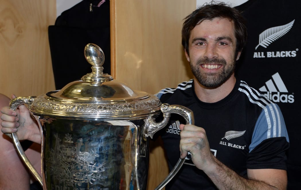 The All Blacks Conrad Smith in the dressing room with Bledisloe Cup.