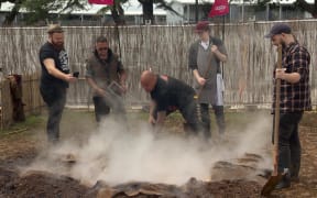 Rewi Spraggon guides chefs in the art of hangi making.