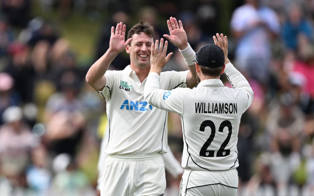 Matt Henry and Kane Williamson celebrate the wicket of Nathan Lyon on Day 3 of the 1st cricket test match between New Zealand and Australia at the Basin Reserve in Wellington.