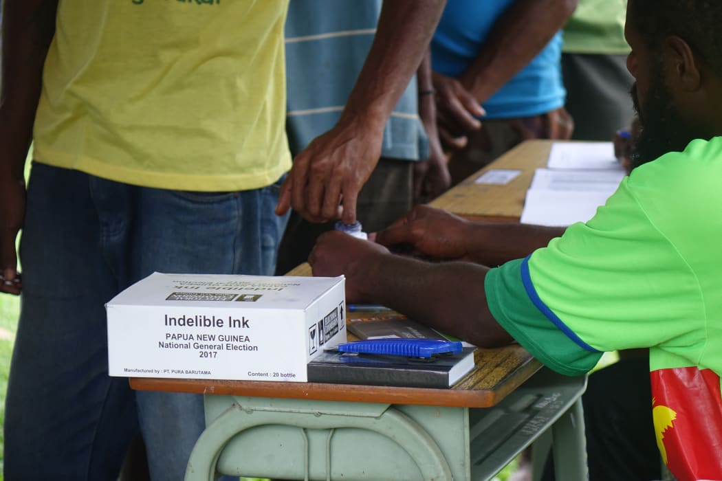 Indelible ink is used at a polling booth in Papua New Guinea's national election.