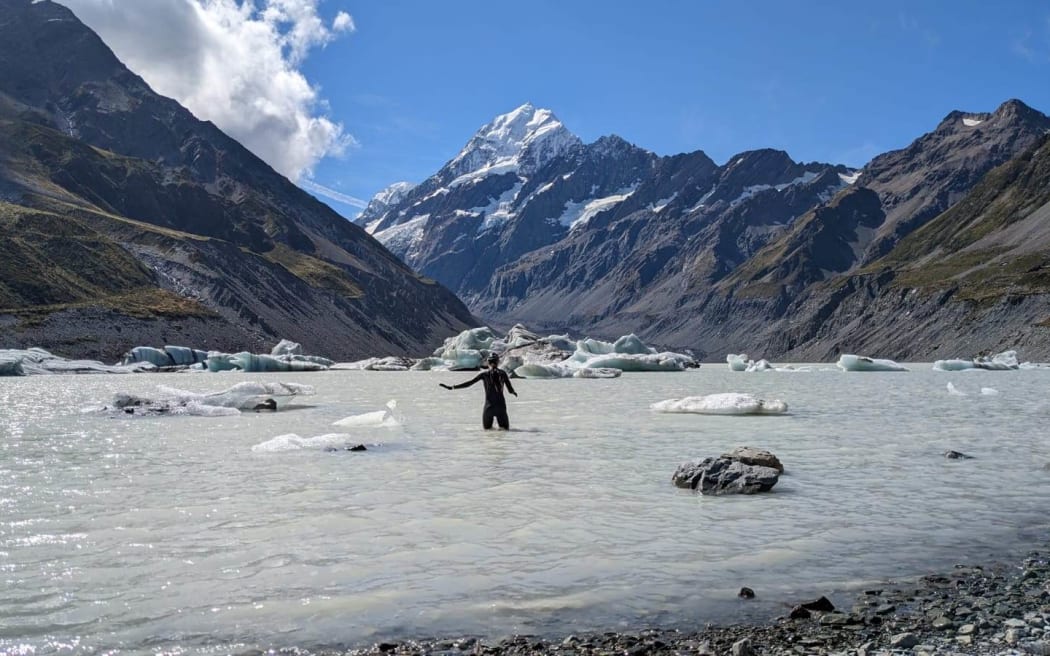 Sara Metzger swimming in Hooker Lake with Mt Cook in the background