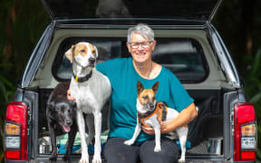 image of retired animal services officer Betty Hall with her dogs Quinn, Neville and Alfie.