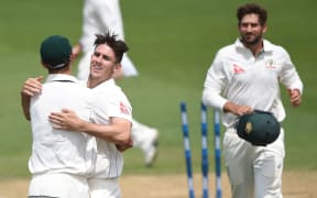 Australian bowler Mitchell Marsh celebrates taken the final New Zealand wicket to win the first test.