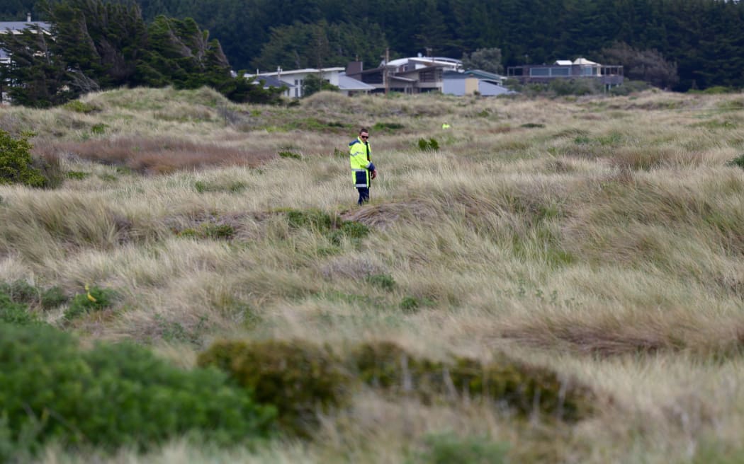 Police near the scene where 10-year-old Alex Fisher's body was found.