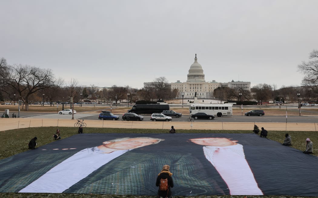 A photo of President Donald Trump and convicted sex offender Jeffrey Epstein is unfurled on the National Mall near the U.S. Capitol by the political protest organizations Everyone Hates Elon and Glasgow Actions Team on December 15, 2025 in Washington, DC. The U.S. Department of Justice is required by the Epstein Files Transparency Act to release files related to Epstein on December 19.   Heather Diehl/Getty Images/AFP (Photo by Heather Diehl / GETTY IMAGES NORTH AMERICA / Getty Images via AFP)