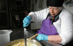 Biddy making cheese at her Eketahuna factory.