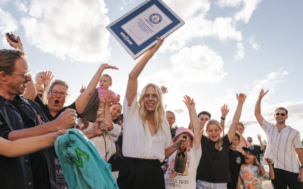 Laura Enever accepts the official Guinness World Record certificate for largest wave surfed paddle-in (female) on November 6, 2023 at Sydney.