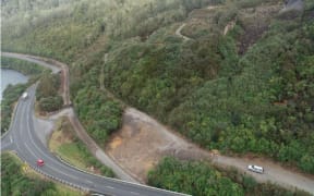 An aerial view of the cleared slip marked in yellow below the Kiwi quarry access road. The slip came down on to the Greymouth-Stillwater railway on June 13, and the Tranz Alpine passenger train ran into the slip near the rail overbridge, bottom. The quarry is owned by the West Coast Regional Council and the access road by the Grey District Council. The quarry has been closed for several years.