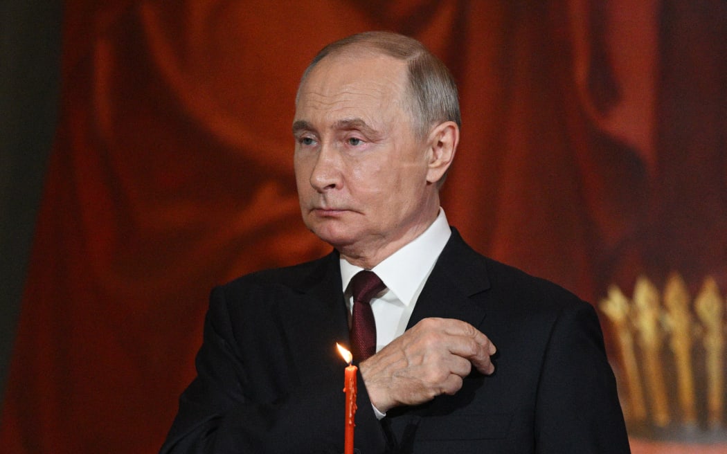 In this pool photograph distributed by Russian state agency Sputnik, Russia's President Vladimir Putin attends an Orthodox Easter service at the Christ the Saviour Cathedral in Moscow early on April 20, 2025. (Photo by Ramil SITDIKOV / POOL / AFP)