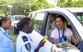 Solomon Islands Police officer about to administer a passive alcohol breath test.