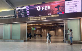 A passenger goes through the departure gate at Auckland Airport on the day the trans-Tasman bubble opened, 19 April 2021.