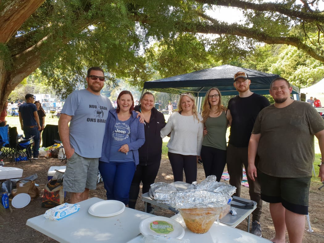Schane and Marius Davis (left) enjoying a braai with fellow South Africans in south Auckland