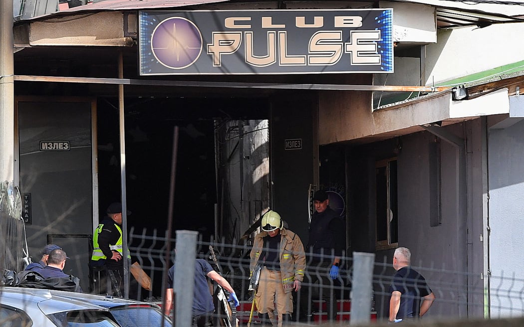 Firefighters and police officers inspect the nightclub where a fire broke out overnight in Kocani, a town some 100 kilometres east of the capital Skopje, on March 16, 2025. A fire tore through an overcrowded nightclub packed with mostly young people in North Macedonia overnight, killing 59 people, apparently after on-stage fireworks at a hip-hop concert set the venue ablaze, authorities said. Some 155 people who were injured in the inferno had been taken to hospitals across the country, 22 of them in critical condition, officials said. (Photo by Robert ATANASOVSKI / AFP)