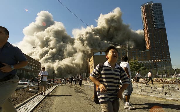 NEW YORK - SEPTEMBER 11, 2001: (PUERTO RICO OUT) (SEPTEMBER 11 RETROSPECTIVE) People run away as the North Tower of World Trade Center collapses after a hijacked airliner hit the building September 11, 2001 in New York City. Jose Jimenez/Primera Hora/Getty Images/AFP (Photo by Jose Jimenez/Primera Hora / GETTY IMAGES NORTH AMERICA / Getty Images via AFP)