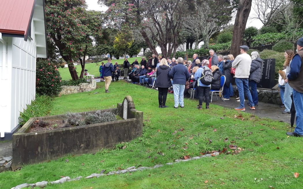 Daniel Chrisp speaks at the Family Forum beside the Porirua Cemetery chapel, as Mayor Anita Baker and whānau gather to honour 1800 patients buried in unmarked graves.