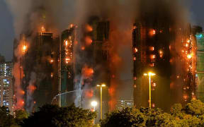Thick smoke and flames rise as a major fire engulfs several apartment blocks at the Wang Fuk Court residential estate in Hong Kong's Tai Po district on 26 November, 2025.