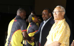 PM James Marape (c) and PNG Olympic Committee President Sir John Dawanicura (R) with athletes at the Team PNG farewell ceremony.