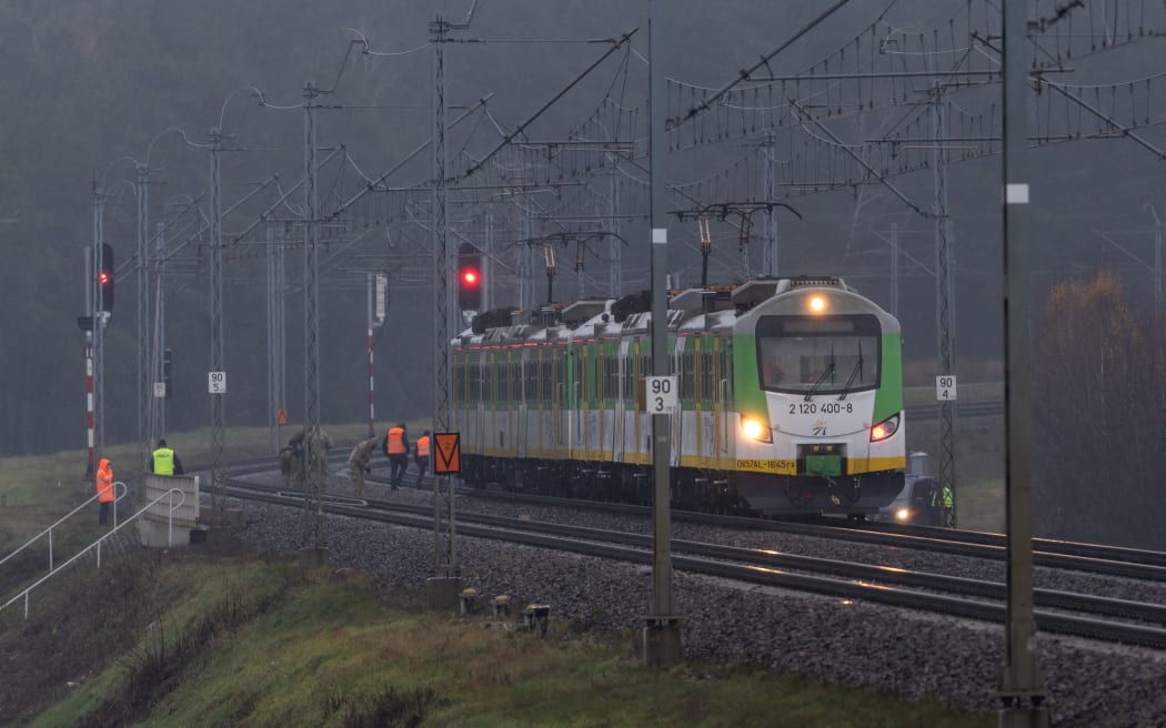 Investigators examine the railways damaged in an explosion on the rail line in Mika, next to Garwolin, central Poland on November 17, 2025, after the line presumably was targeted in a sabotage act. Polish Prime Minister Donald Tusk said on November 17, 2025 that an explosion which damaged a railway line to its close ally Ukraine was an "unprecedented act of sabotage". The damage, which authorities have said was discovered on Sunday, November 16, directly targeted "the security of the Polish state and its civilians," Tusk wrote on X. The explosion was on the rail link running from Warsaw to the Polish city of Lublin and connects to a line serving Ukraine.