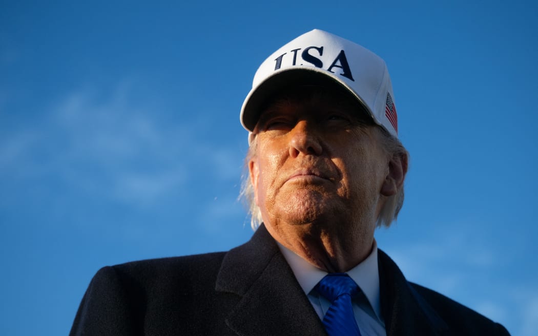 US President Donald Trump speaks to reporters before boarding Air Force One as he departs Joint Base Andrews in Maryland on March 13, 2026. President Trump is heading to Florida to spend the weekend at his Mar-a-Lago resort. (Photo by SAUL LOEB / AFP)