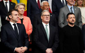 (From L) France's President Emmanuel Macron, Britain's Prime Minister Keir Starmer and Ukraine's President Volodymyr Zelensky pose for a family photograph during a summit held at Lancaster House in central London on March 2, 2025. European leaders descend upon London today for talks to "drive forward" action on Ukraine, according to the office of UK Prime Minister Keir Starmer. The summit caps off a week of intense diplomacy for host Starmer, who met with President Donald Trump on Thursday in an effort to draw together the European and US approaches to the Ukraine conflict. (Photo by Christophe Ena / POOL / AFP)