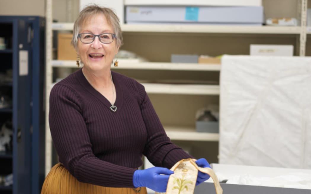 Gail Romano, Auckland Museum's associate curator of war history, with artifacts belonging to World War I Reverend Charles Bush-King