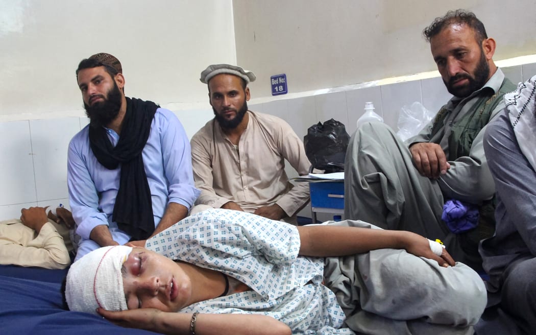 An injured Afghan boy (bottom) receives treatment at a hospital after an earthquake in Afghanistan's Jalalabad on September 1, 2025. Nine people died when a 6.0-magnitude earthquake and powerful aftershock rattled eastern Afghanistan, the provincial Nangarhar government said on September 1. (Photo by Aimal ZAHIR / AFP)