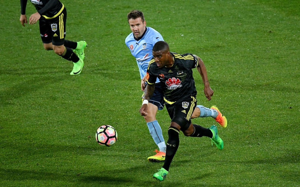 The Phoenix's Rolieny Bonevacia (front) dribbles the ball with Sydney FC's Milos Dimitrijevic during their A-League football match at Westpac Stadium in Wellington.