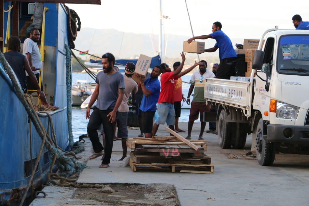Donated goods being loaded onto a ship in Port Vila preparing to sail for Ambae.