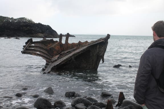 This is an image Kurt Bennett and the remains of the steamship Ngapuhi at 'Wreck' Bay.