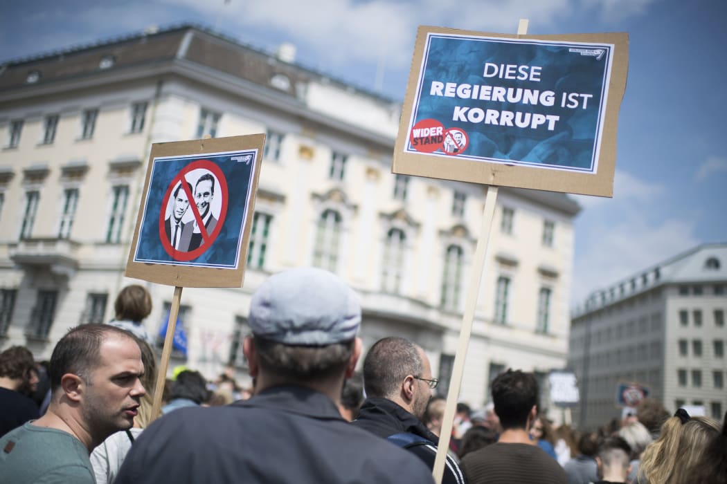 Demonstrators gather in front of the Austrian Chancellors Office in Vienna, Austria, Saturday, May 18, 2019. Slogan reads: 'This Government Is Corrupt'.