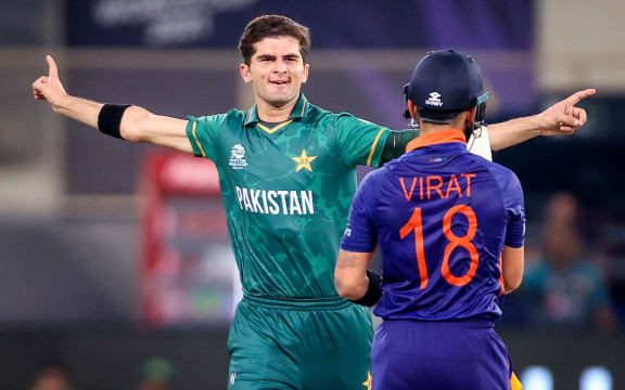 Pakistan's Shaheen Shah Afridi (L) reacts after dismissing India's captain Virat Kohli during the ICC Men's T20 World Cup match