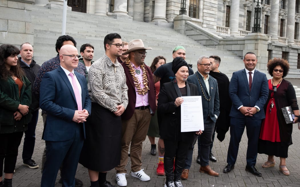 MPs, supporters and the co-authors of the petition gather for photos.