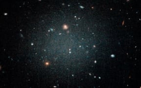 The NGC1052-DF2 galaxy is so thin other galaxies can be seen through it, as seen in this image from the Hubble telescope.