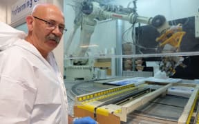 Kerry Bourke monitors the robotic helmet form maker at Pacific Helmets.