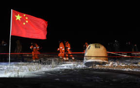 The return capsule of China's Chang'e-5 probe lands in Siziwang Banner, north China's Inner Mongolia Autonomous Region, on Dec. 17, 2020.