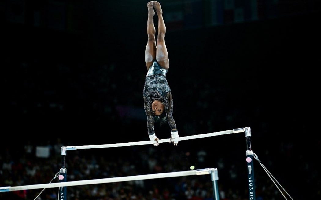 US' Simone Biles competes in the uneven bars event of the artistic gymnastics women's qualification during the Paris 2024 Olympic Games at the Bercy Arena in Paris, on July 28, 2024.