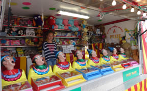 Georgia Avery helps out her dad, Jason, at his concession stand at the Canterbury A& P show.