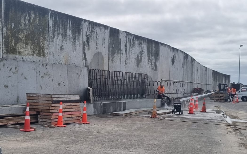 The concrete footing and tapered concrete reinforcing wall begin to take shape.
