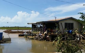 At a house in Lovu, near Lautoka, people wait for clean drinking water to arrive.