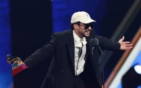 Puerto Rican singer Bad Bunny accepts the Album of the Year award for "DeBI TIRAR MaS FOToS" during the 26th Annual Latin Grammy Awards at the MGM Grand Garden Arena in Las Vegas, Nevada on November 13, 2025. (Photo by VALERIE MACON / AFP) / RESTRICTED TO EDITORIAL USE