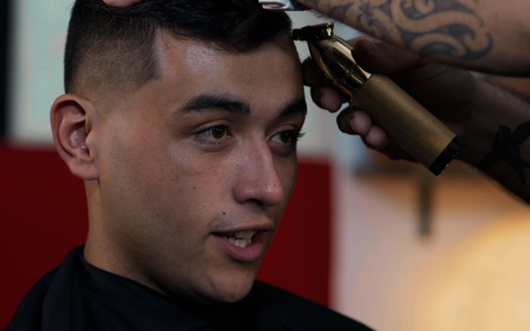 Shareef gets some final touch ups in the barbers chair.