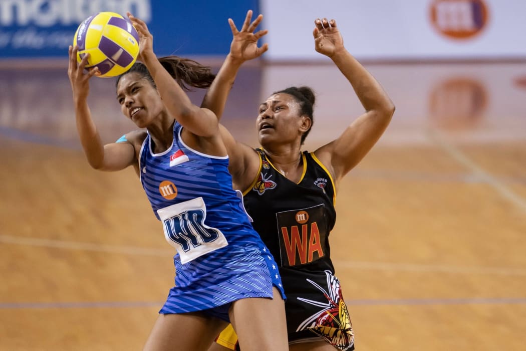 Singapore and PNG battle for the ball