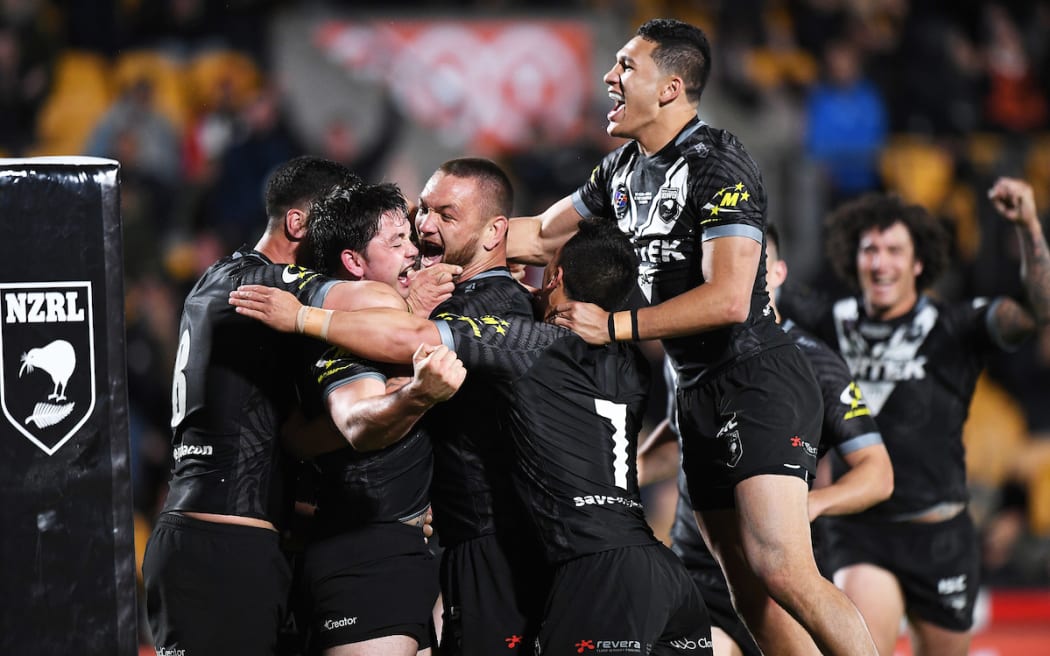 Dallin Watene-Zelezniak and team mates celebrate a try to Brandon Smith.