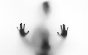 hands behind glass