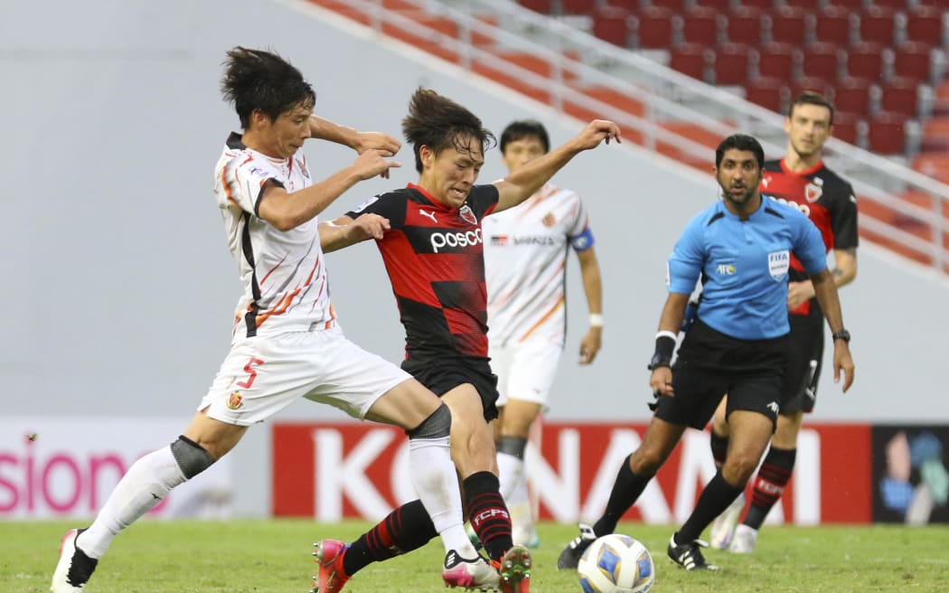 Kazuki Nagasawa (right) playing for Japan's Nagoya Grampus battles for the ball with South Korea's Pohang Steelers player Goh Young-jun an AFC Champions League group match in 2021.