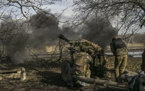 Ukrainian servicemen fire a 105mm Howitzer towards Russian positions, near the city of Bakhmut, on March 4, 2023. (Photo by Aris Messinis / AFP)