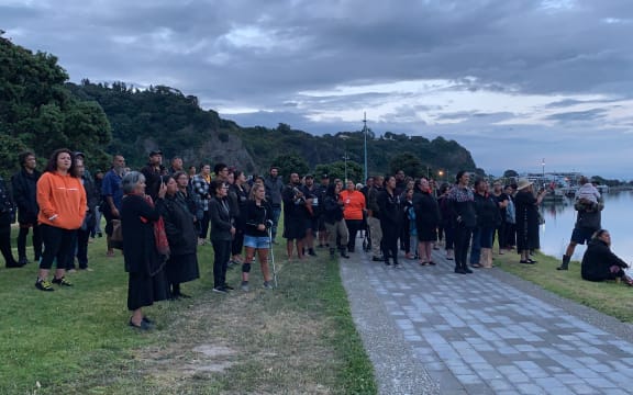 About 50 whānau, friends and members of the local community gather for a karakia at the cordon at the Whakatāne Boat Ramp.