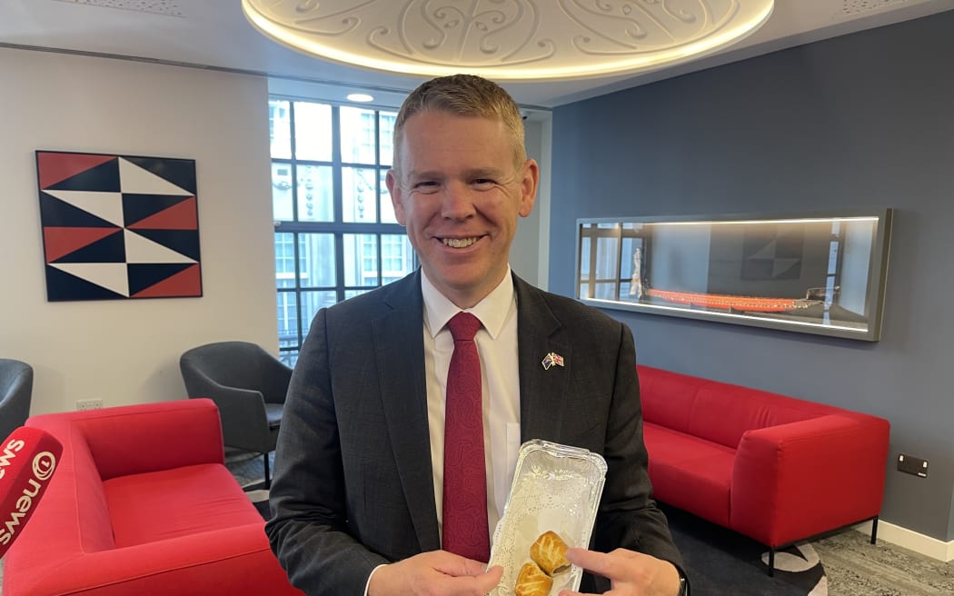 Prime Minister Chris Hipkins holds sausage rolls - a well-known favourite of his - which had been made specially for his meeting with King Charles at Buckingham Palace.
