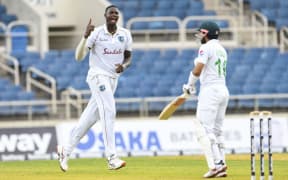 Jason Holder (L) of West Indies celebrates the dismissal of Mohammad Rizwan (R) of Pakistan during day 1 of the 1st Test between the West Indies and Pakistan at Sabina Park, Kingston, Jamaica, on August 12, 2021.