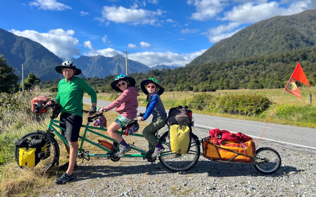 Andrew Hughes, daughter Hope (10) and son Wilfy (8) on their triplet bike.